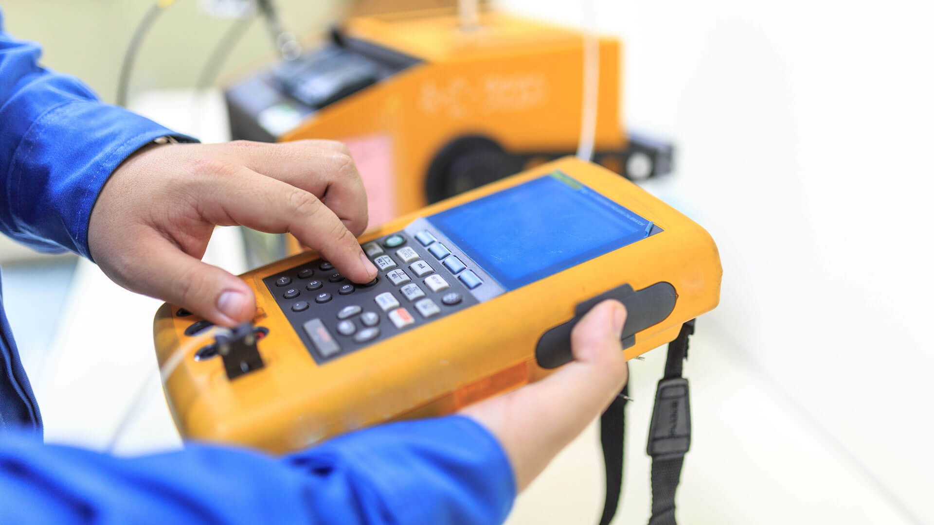 Image of a person using a technical instrument in the field