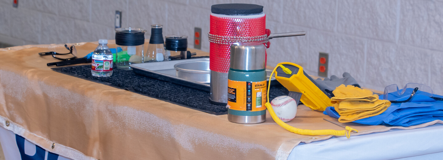 A table covered in beakers, monitors and other tools used in LNG safety