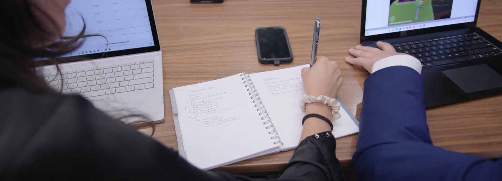 A close up on NextDecade employee hands looking over a data sheet on a conference table