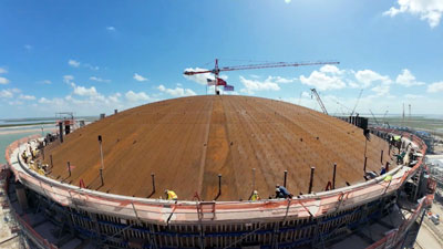 Workers securing the roof to a LNG tank
