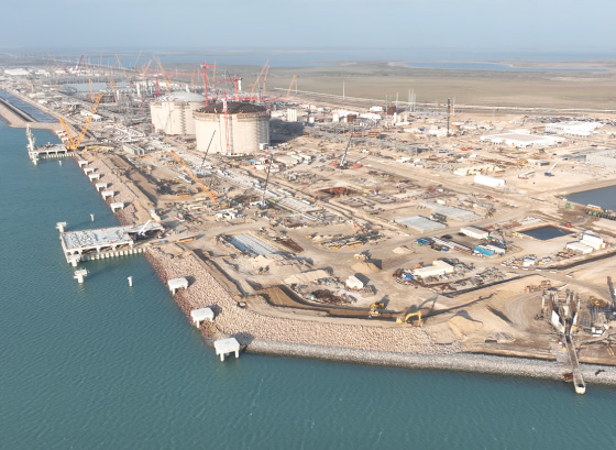 A refinery shown near a body of water