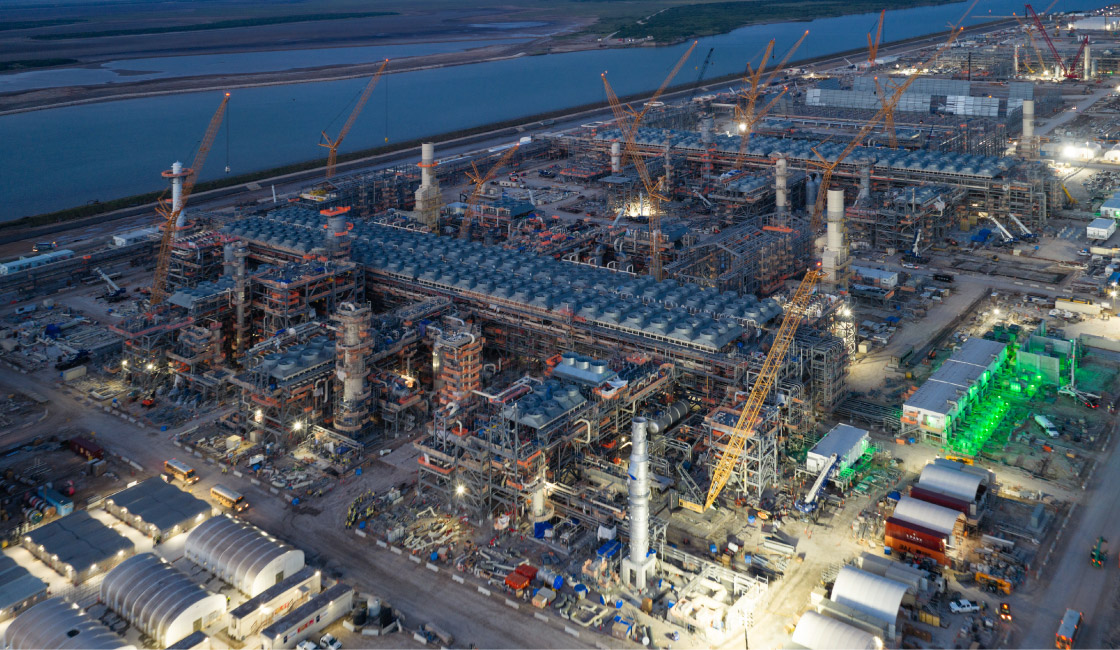 RGLNG at dawn with yellow and red construction cranes scattered across the LNG terminal